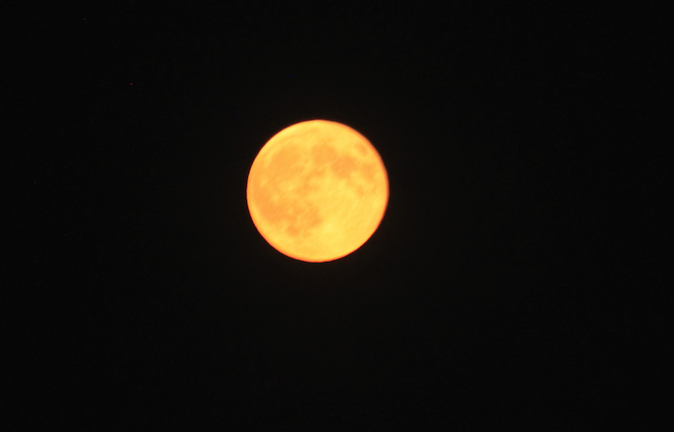 An orange moon over Lincoln caused by wild fires in the northwest U.S.