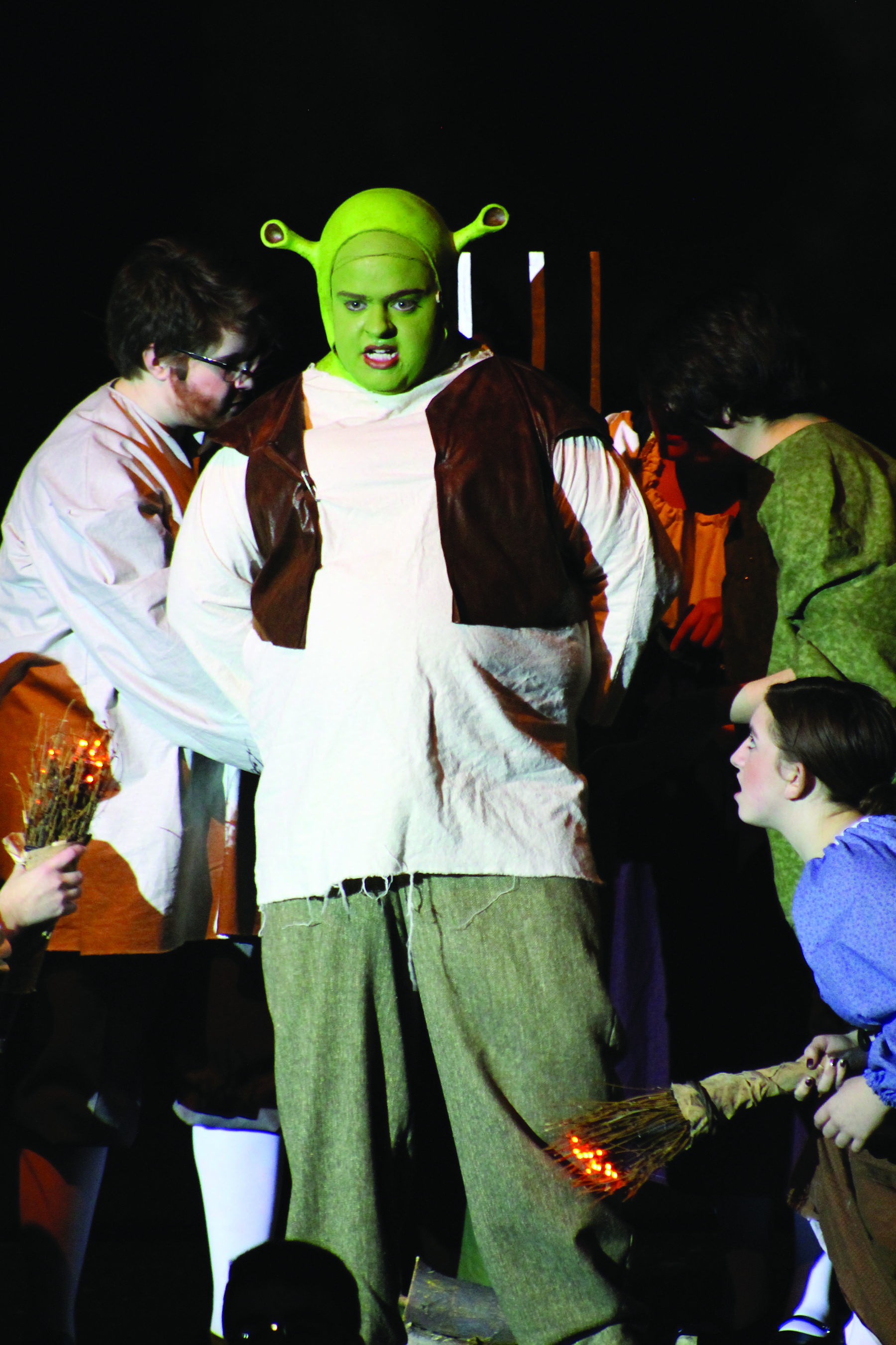 Shrek (senior Chaney Bernt) prepares to be burned at the stake by townspeople during the opening number of “Shrek: The Musical.” Photo by Sarah Kay/GG Staff
