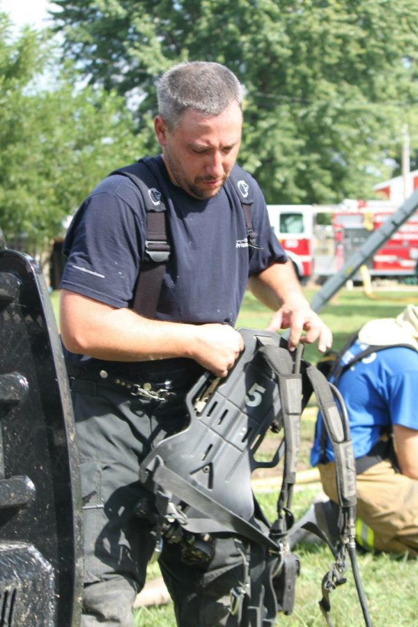 A volunteer firefighter with the Valparaiso Rural Fire Department organizes equipment during training.
Courtesy Photo
