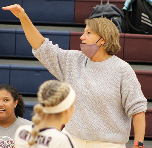 Coach Kristi Nelson-Hitz shouts instructions to her players on the court during a varsity volleyball game at North Star High School.
