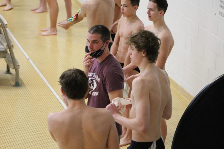 Coach John Hower, left, talks with diver Jordan Kramer during the HAC tournament at Southeast High School