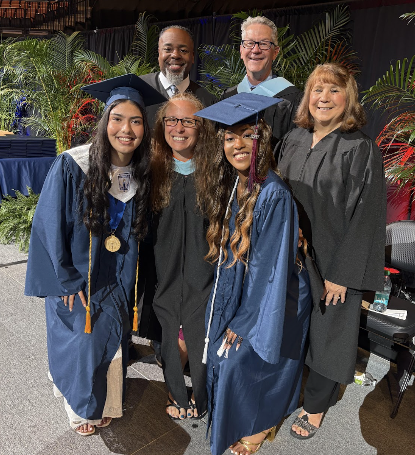 Smiling after last year's graduation ceremony, Mrs.Kroll stands for a photo with graduates and LPS staff members. Kroll looks forward to cheering on her students during the graduation season.