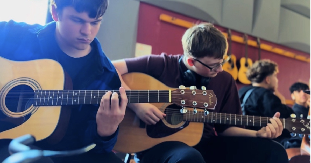 
Senior Bryce Hawney and Senior William Abbott jamming out together on the guitar. 
