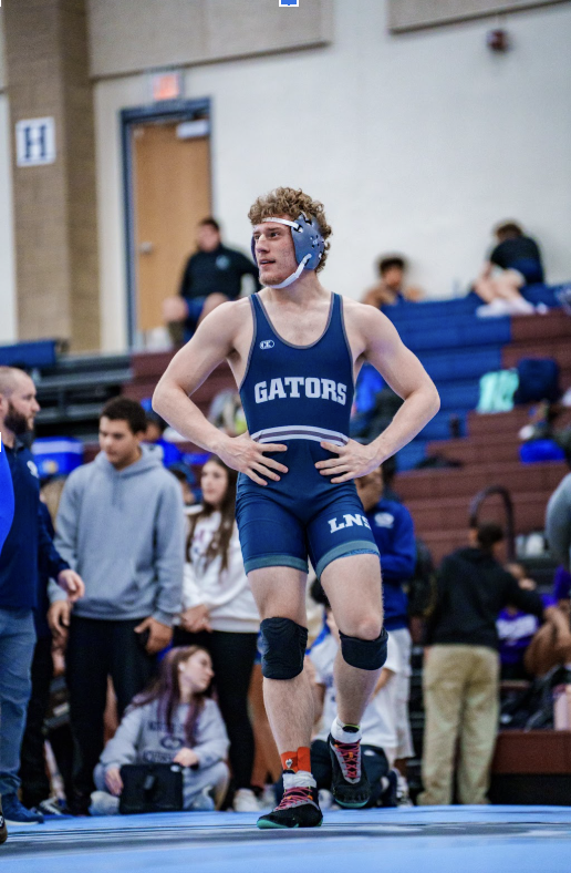 175 Pounder JC Seivers (12) smiles as he gets his cut on the bridge of his nose attended to. He would later go on to win the match by fall in the second period.
